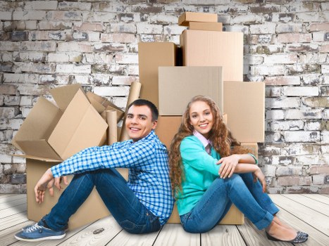Moving day preparation with labelled boxes and wrapped furniture