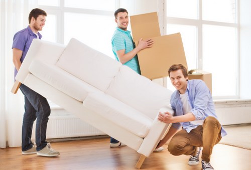 Commercial movers handling desks and office equipment during a Harringay move