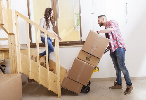 Local movers carrying furniture in a Harringay residential street